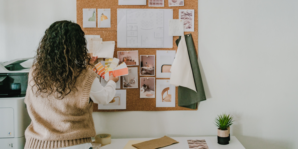 Girl pinning images to a vision board