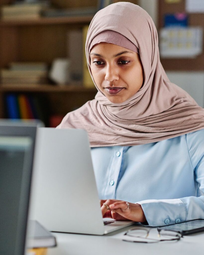 Woman working on computer. Small Business Grants: What They Are and Where to Find Them